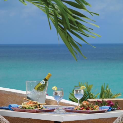 The image depicts a delightful beachside dining setting