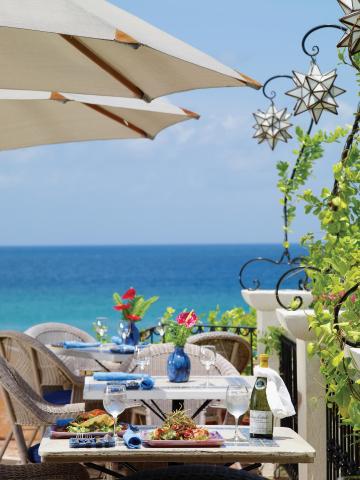 This is an image of a beautifully set seaside dining area