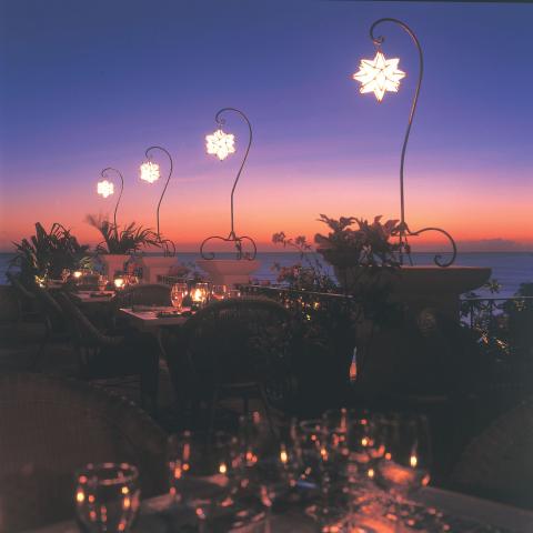This image shows an elegant outdoor dining setting at twilight