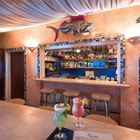 This image shows a colorful and inviting bar area, probably within a restaurant or hotel