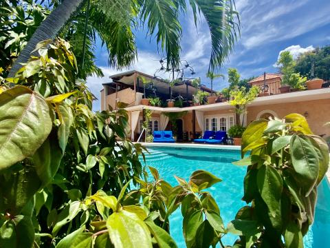 This image features an inviting outdoor residential scene with a swimming pool