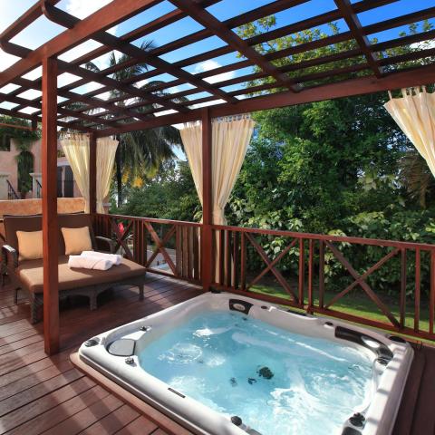 This image shows a luxurious outdoor space on a wooden deck