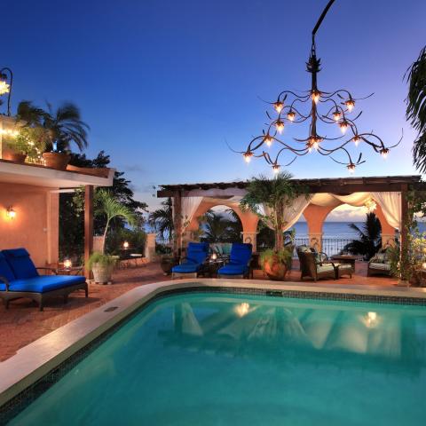 This image features a luxurious outdoor setting at twilight