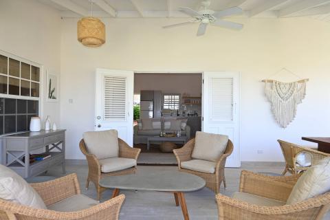 The image shows a tastefully decorated interior space with a coastal or tropical design aesthetic