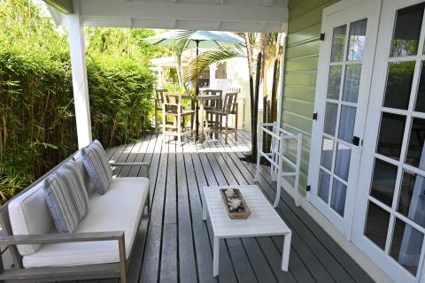 This image features an outdoor patio area of a home, designed with a cozy and inviting layout