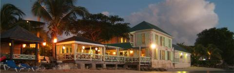 This image shows a tropical beachside scene at dusk