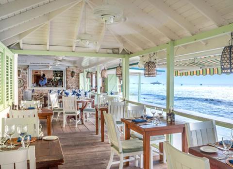 This image shows a beachfront restaurant setting
