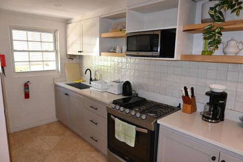 The image shows a modern kitchen with various appliances and utensils