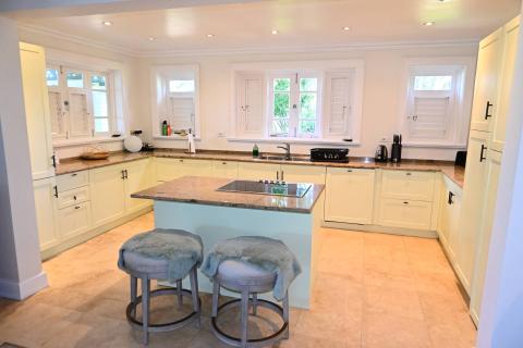 The image shows a spacious kitchen featuring a modern design