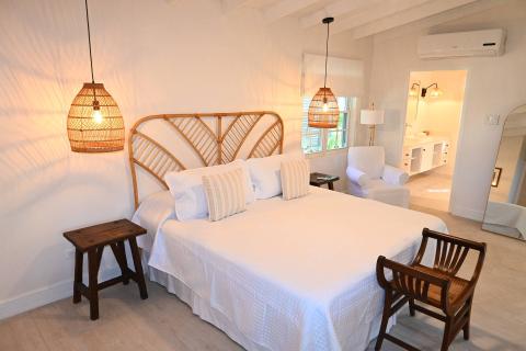 The image shows a warmly lit, well-decorated bedroom