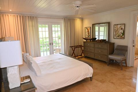 The image shows a well-appointed bedroom, featuring elements typical of a modern yet cozy interior design