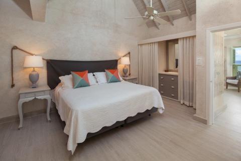 The image shows a well-decorated bedroom with a neutral color palette
