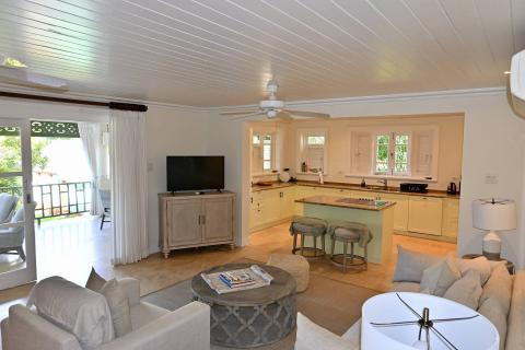 This image features an elegantly decorated interior space that serves as both a living area and a kitchen