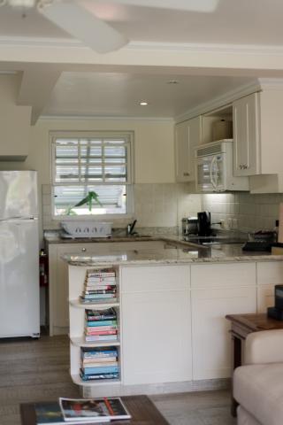 This image shows a modern kitchen featuring an array of pale-toned cabinetry, which contributes to a clean and homely aesthetic