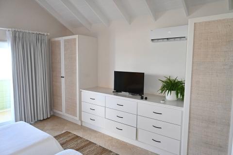 This image shows a neatly organized and modern bedroom interior