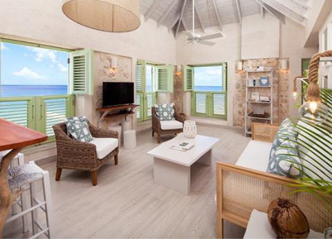 The image depicts a bright and airy beach house living room with a seaside theme