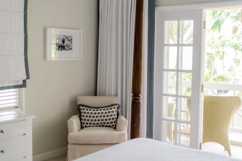 The image shows an interior room, appearing to be part of a house or an apartment, decorated in a sophisticated, airy style