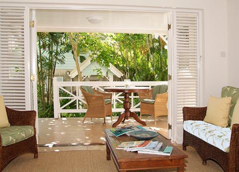 This image shows a well-appointed, open-concept indoor room leading to an outdoor patio