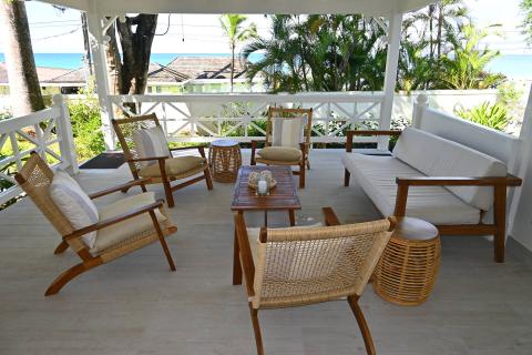 This image shows a beautifully arranged outdoor patio with various types of seating options