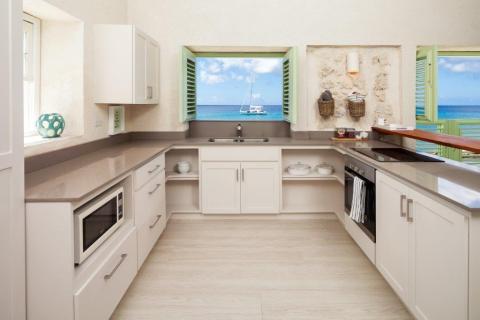 This image displays a modern beachside kitchen interior