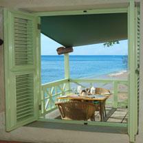 The image shows a scenic view from a window opening out to a beach