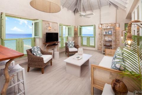 This image depicts a beautifully adorned beachfront living space with a coastal decor theme