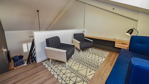 The image shows a stylish loft-style interior that appears to be part of a home