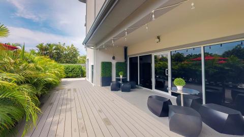 The image shows a modern and stylish outdoor patio area