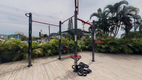 This image shows an outdoor exercise area equipped with various fitness stations
