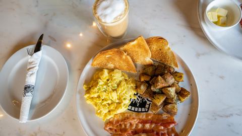 The image shows a breakfast setting on a marble table