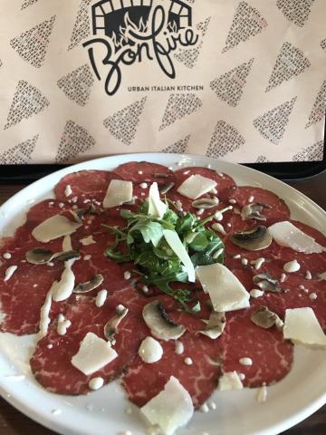 The image shows a plate of beef carpaccio