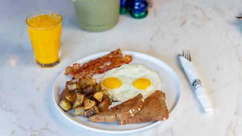 This image features a breakfast meal set on a white marble table