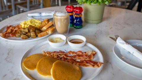 This image features a breakfast setting on a white marble table
