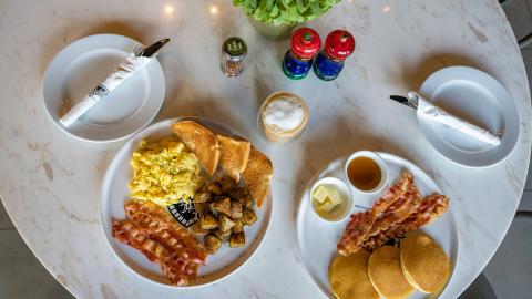 This image features a breakfast setup on a marble table