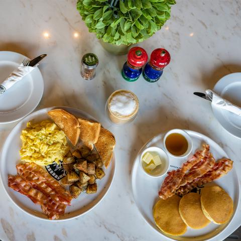 This image features a breakfast spread on a marbled table