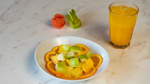 This image features a healthy and vibrant snack setup on a marble surface