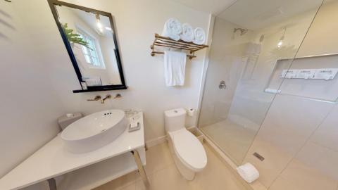 The image features a modern, well-lit bathroom