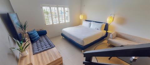 The image shows a contemporary and well-decorated bedroom