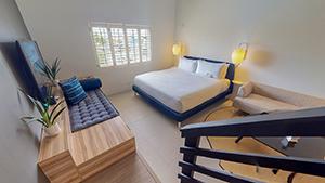 The image shows a contemporary, well-lit bedroom