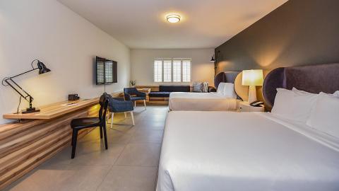 The image shows a modern and well-appointed hotel room