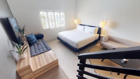 The image shows a modern bedroom with several design elements and furniture pieces