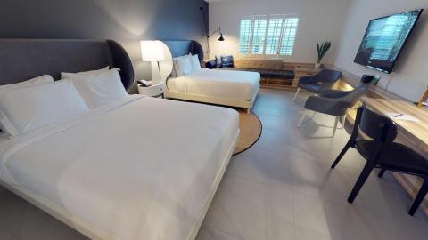 This image shows a modern bedroom with a clean, minimalist design