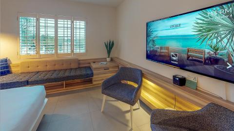 This image shows a modern living room setup with a spacious and minimalist design