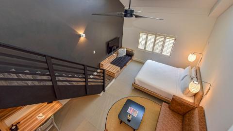 This image shows a modernly designed loft-style bedroom