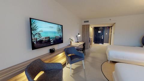 This image shows the interior of a modern and minimalistic hotel room or apartment