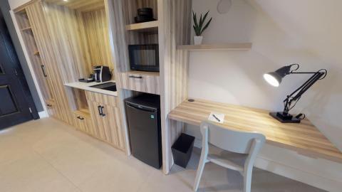 This image shows a modern, compact kitchenette and work area