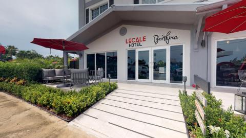 This image shows the exterior of the Locale Hotel, presenting a modern and welcoming setting