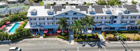 The image shows an aerial view of a large, multi-story building complex with several features