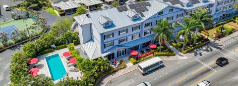 The image shows an aerial view of a modern accommodation complex that appears to be a hotel or apartment building named "Locale