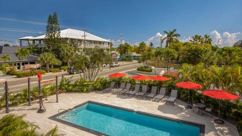 This image shows a sunny outdoor scene featuring a resort or hotel setting